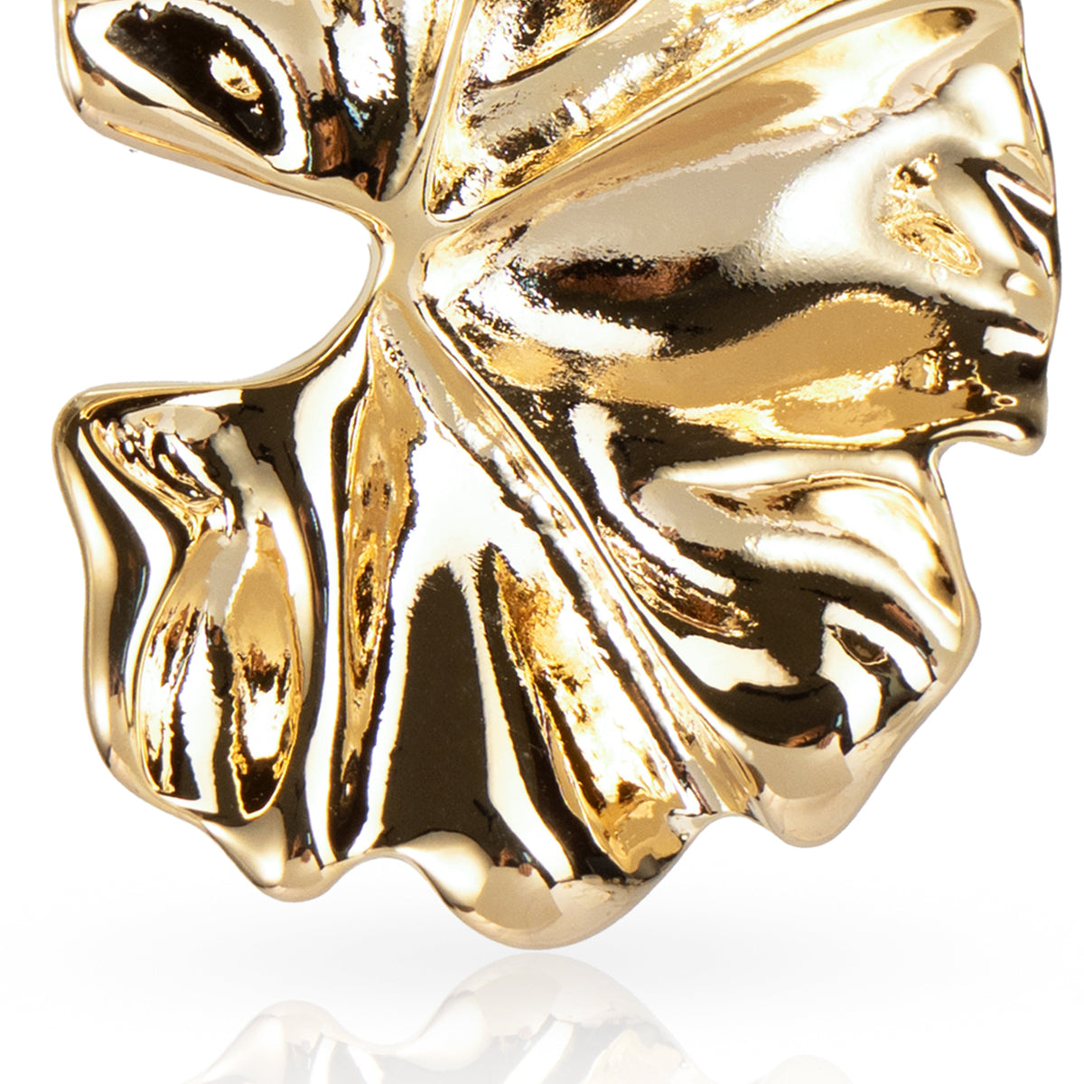 Gold leaf-shaped object on a white background