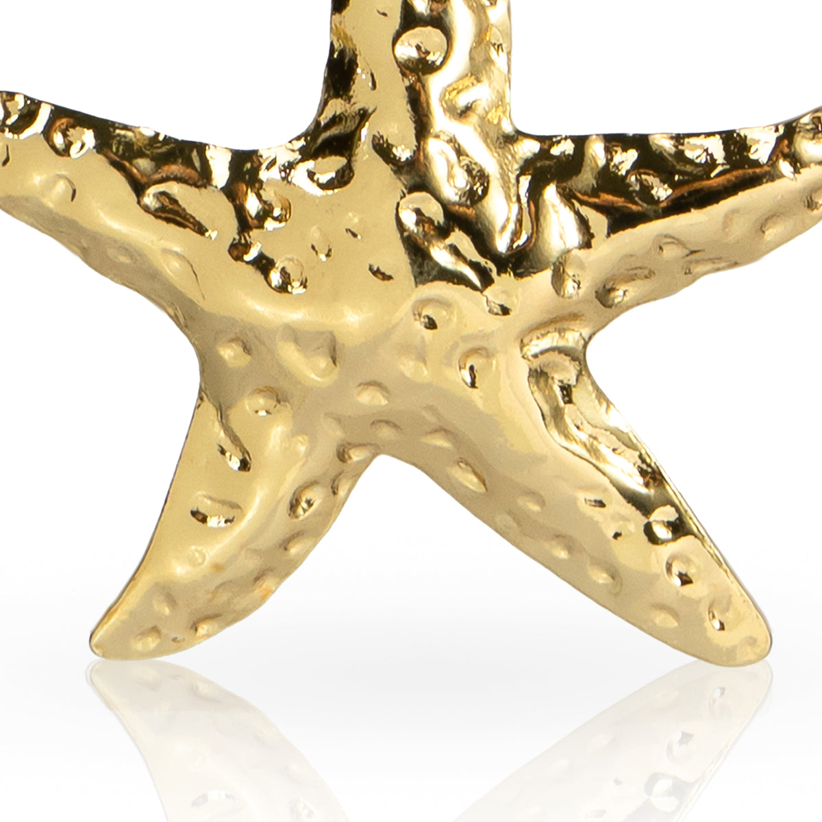 Gold starfish earring on a white background