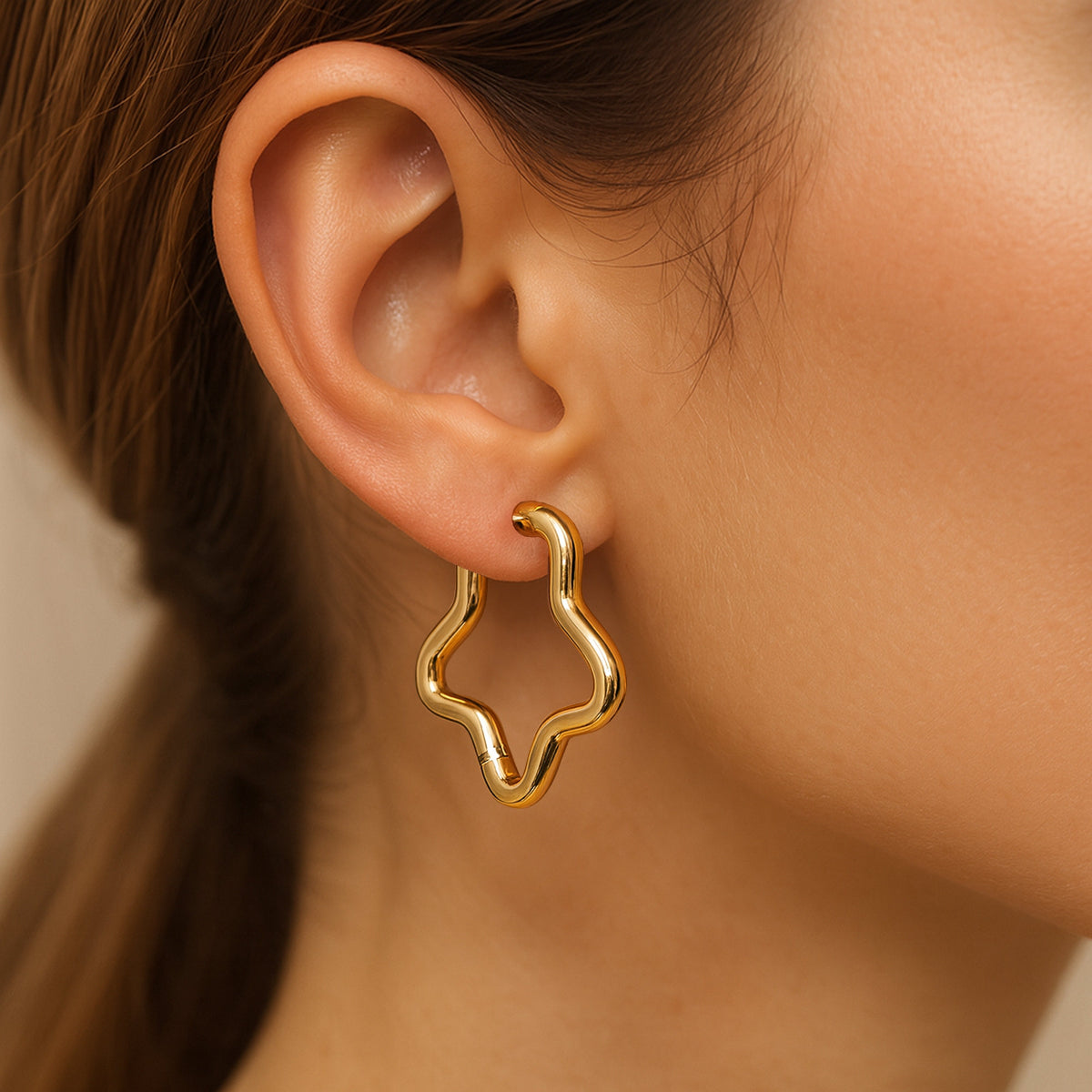 Gold hoop earring on a model