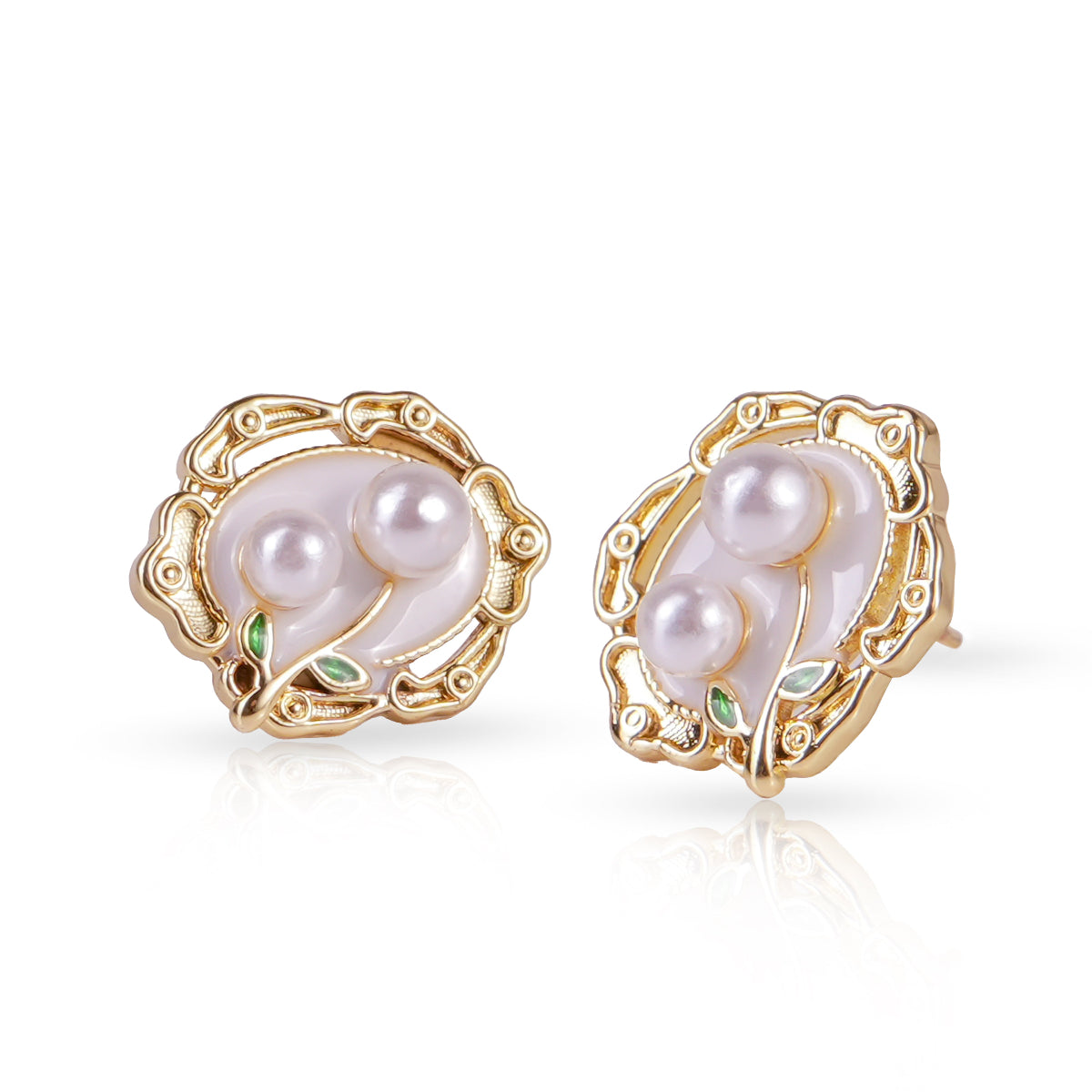 Pair of gold earrings with pearls on a white background
