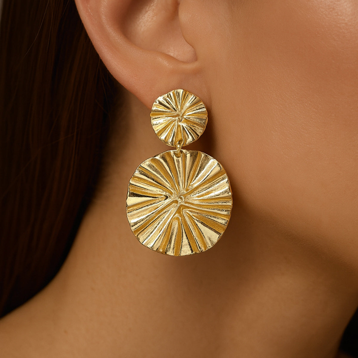 Gold earrings on a model